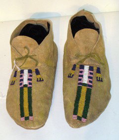 Native American Moccasins: Native American moccasins with beaded designs. Attributed as circa 1860 with the note attached to the bottom of one.