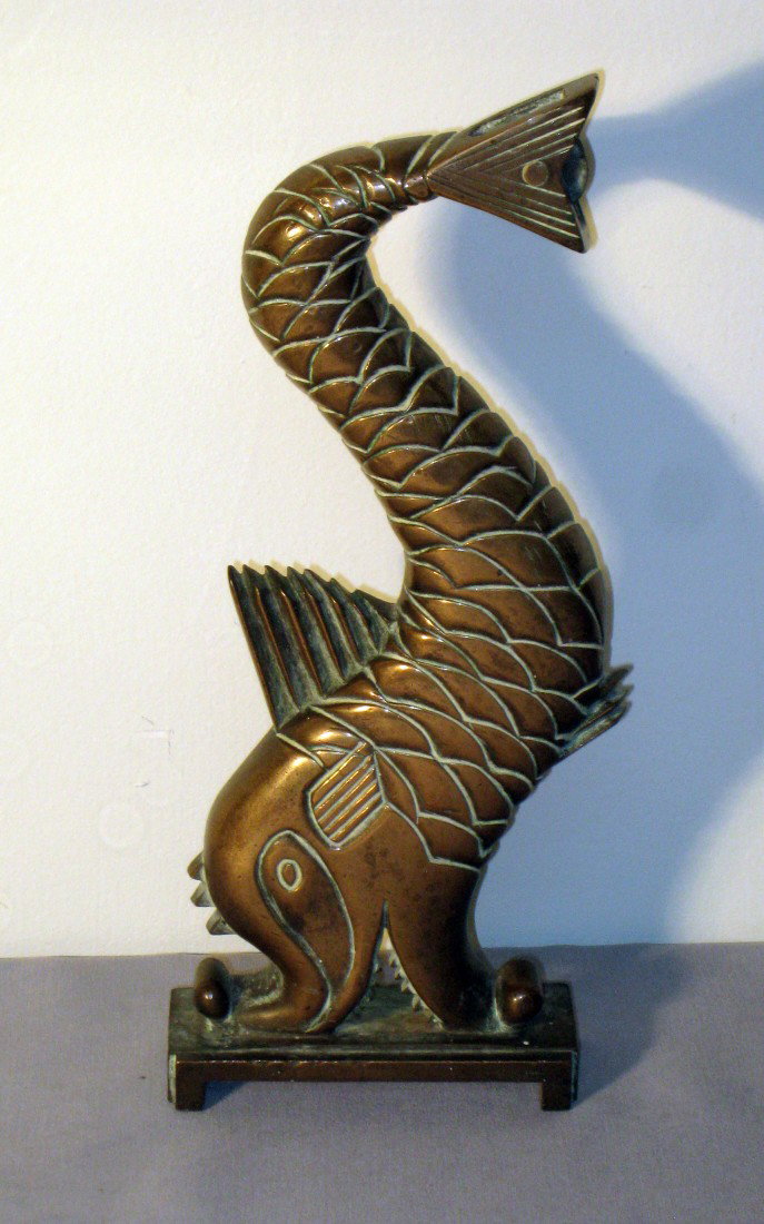 Brass Dolphin Doorstop: This appears to be a doorstop at first look, and it could be used as one, but it is actually some kind of pulley, since there is a pulley wheel mounted at the dolphin's tail. I believe it may have bee