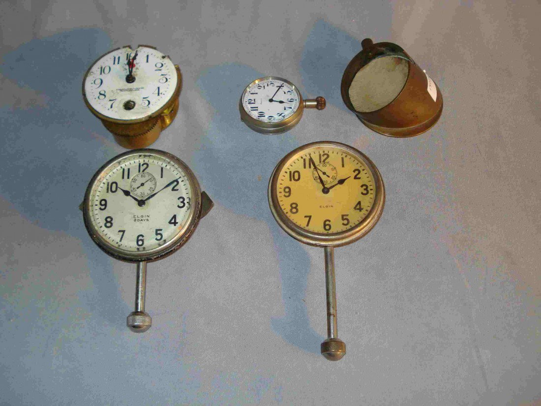 Car Clocks: Four 20th century car clocks: two with long stems by Elgin; one unmarked and with a brass casement for mounting; one in very distressed condition for parts.