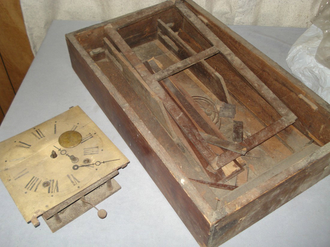 Ogee Clock In Parts: A very early wooden geared ogee clock, dating before 1850. The movement pretty much in tack.