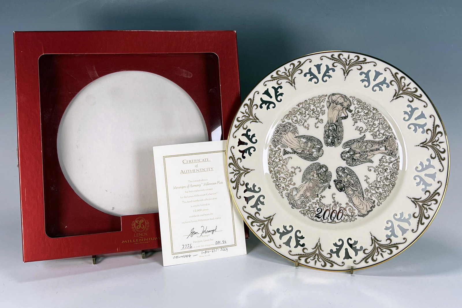 LENOX MILLENNIUM COLLECTION MESSENGERS OF HARMONY PLATE IN BOX: LENOX MILLENNIUM COLLECTION MESSENGERS OF HARMONY PLATE IN BOX Lenox 2000 numbered plate with gold and silver angels and cut-outs along the rim. Comes with certificate of authenticity.