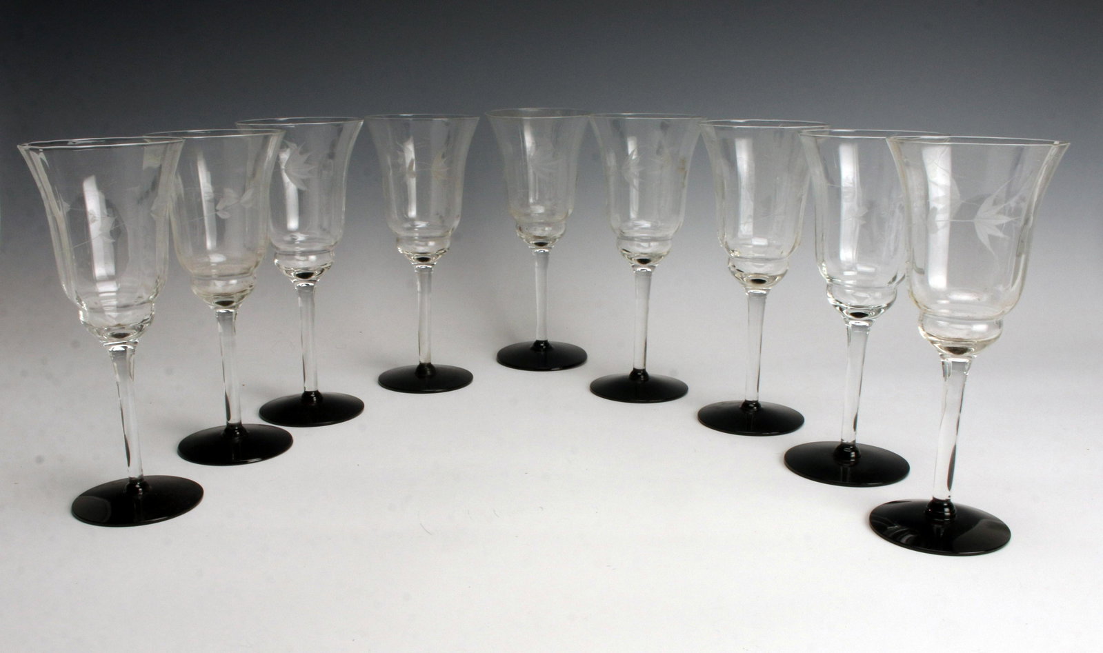 BLACK STEM ETCHED WINE GLASSES: BLACK STEM ETCHED WINE GLASSES Set of nine. Etched floral glasses with black stems. 8" Shipping: Shippi
