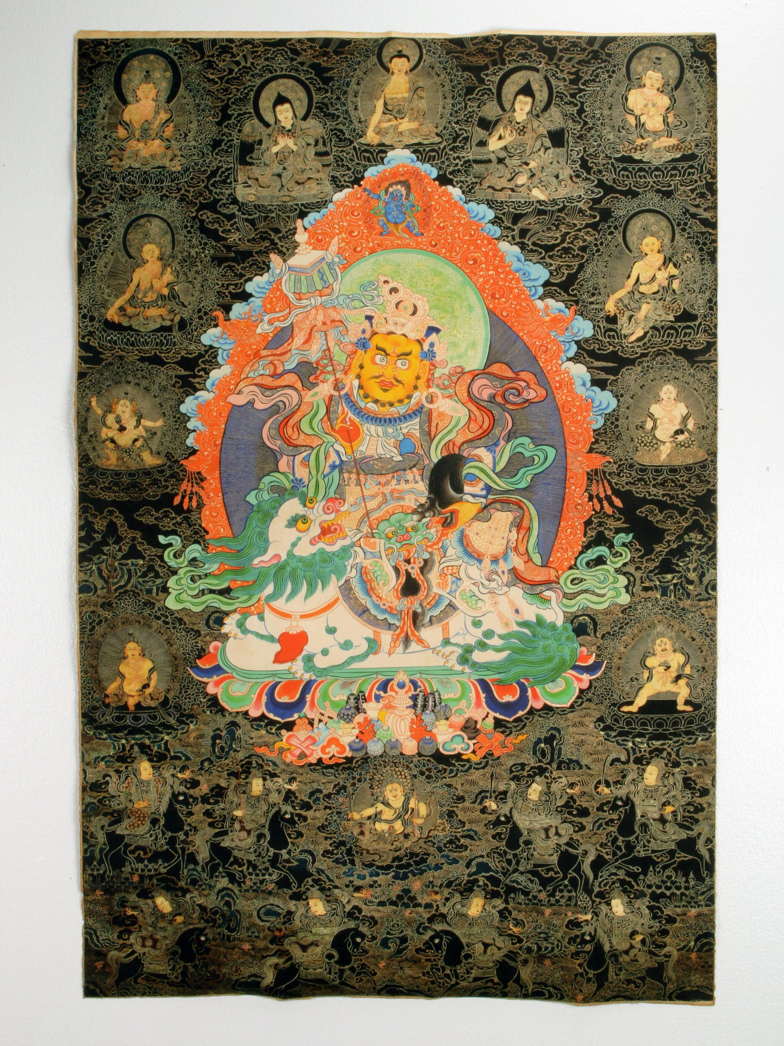 TIBETAN VAISRAVANA GOD OF WEALTH THANGKA: TIBETAN VAISRAVANA GOD OF WEALTH THANGKA Vaisravana is in the center on a beast with flaming features. Small blue Mahakala i