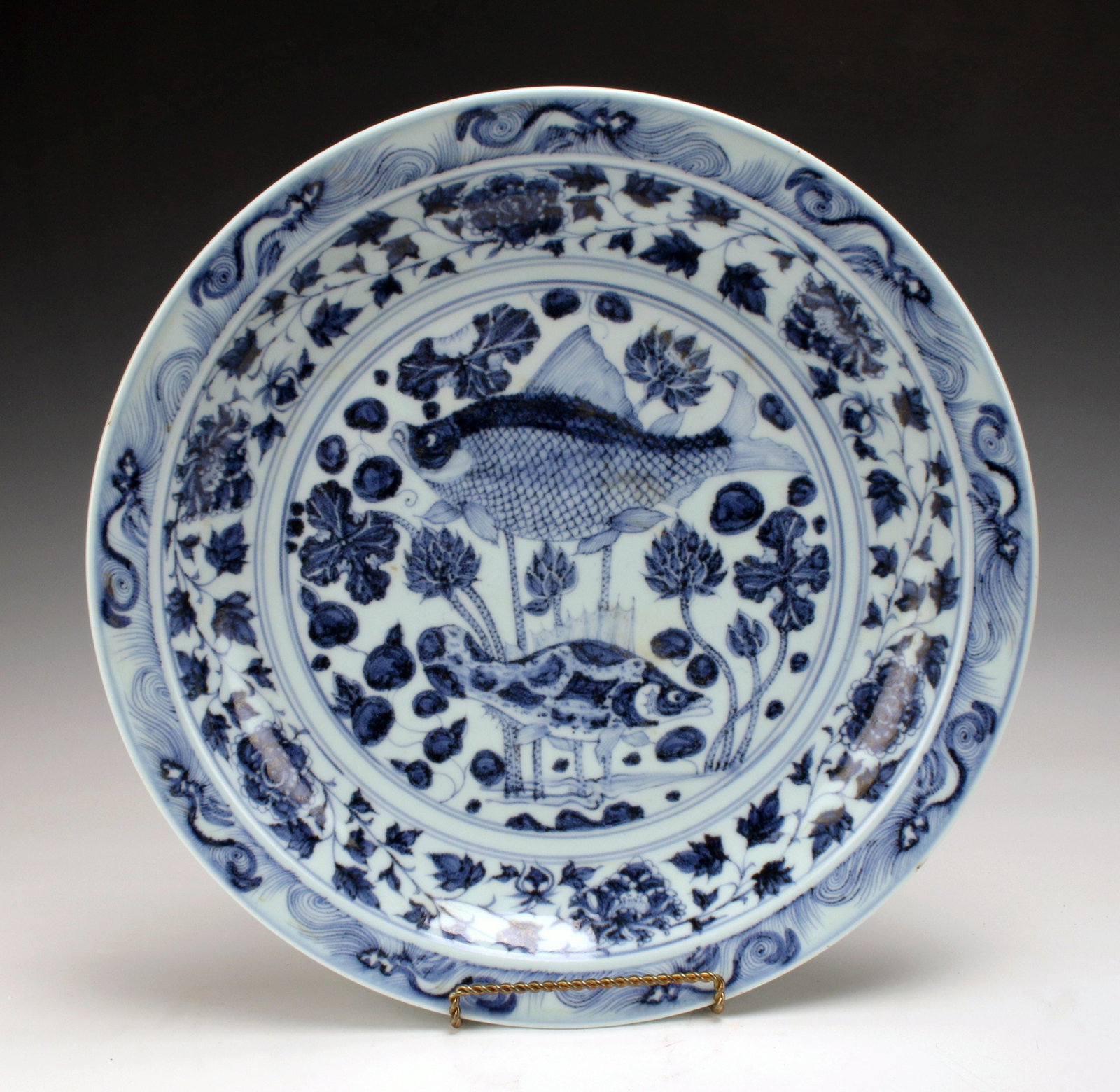 CHINESE BLUE & WHITE FISH CHARGER: CHINESE BLUE & WHITE FISH CHARGER Blue and white charger with flowering tendril border and fish center design. 18" Shipping:</