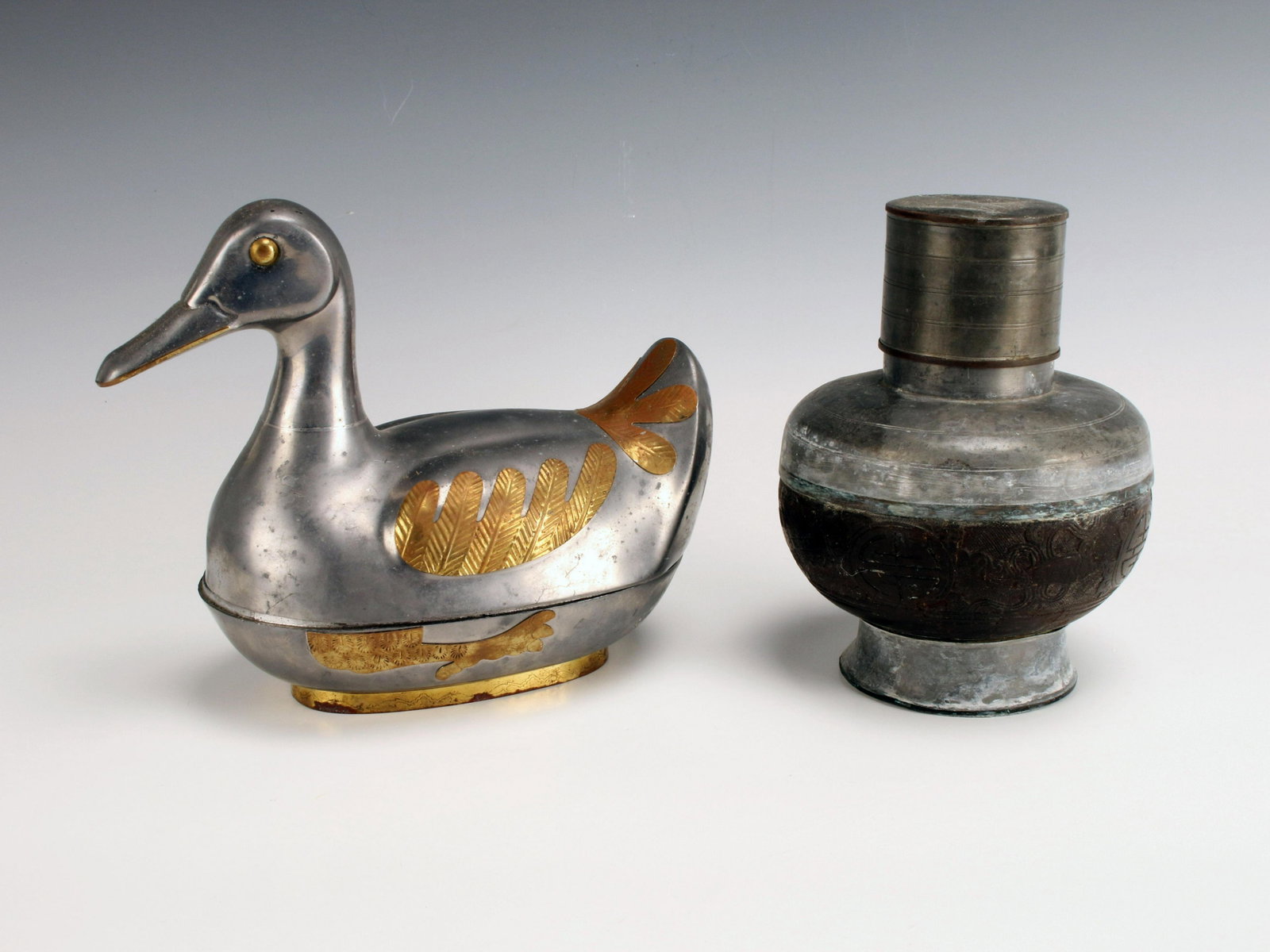 CHINESE LIDDED DUCK DISH AND URN: CHINESE LIDDED DUCK DISH AND URN Chinese urn with carvings on body. Gold and silver colored metal lidded duck dish. 8 1/2" X 7"