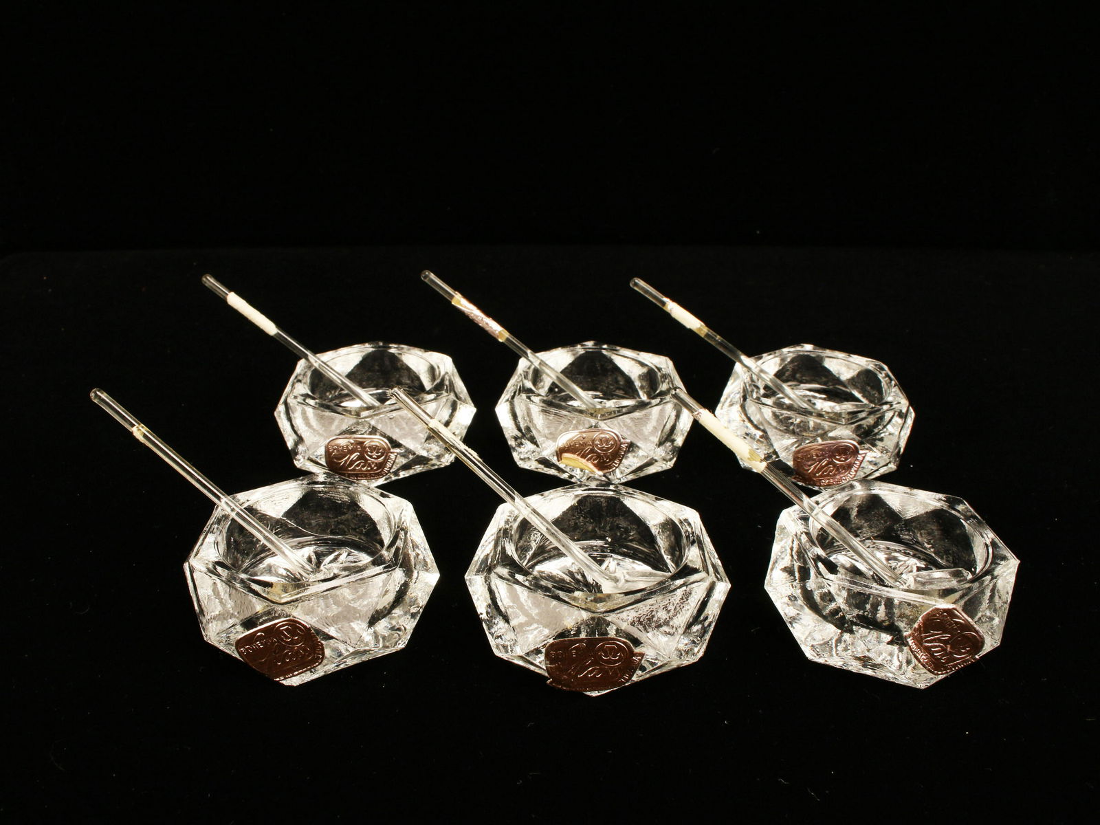 FACETED GLASS SALT CELLARS: FACETED GLASS SALT CELLARS Six cut glass salt cellars with small spoons. 1 3/4" x 1/2" Shipping: