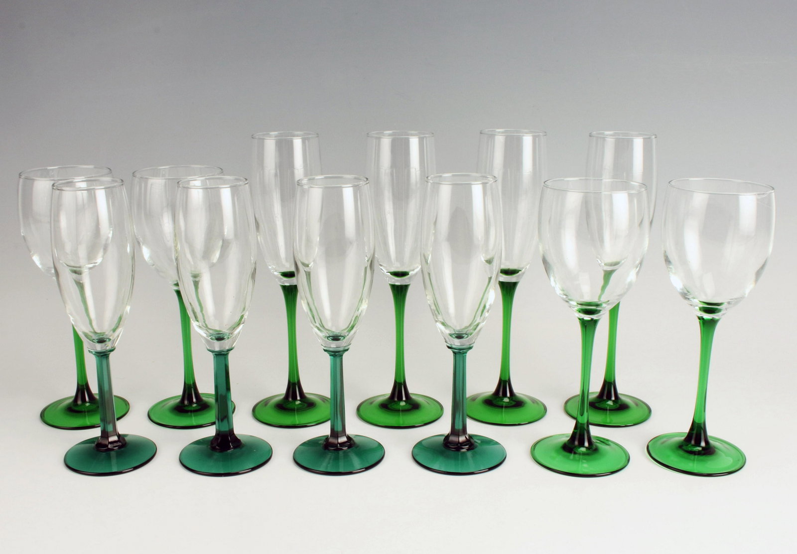 GREEN GLASS STEM WINE CHAMPAGNE GLASSES: GREEN GLASS STEM WINE CHAMPAGNE GLASSES Wine and champagne glasses with green stems. 7 1/2" Shipping: