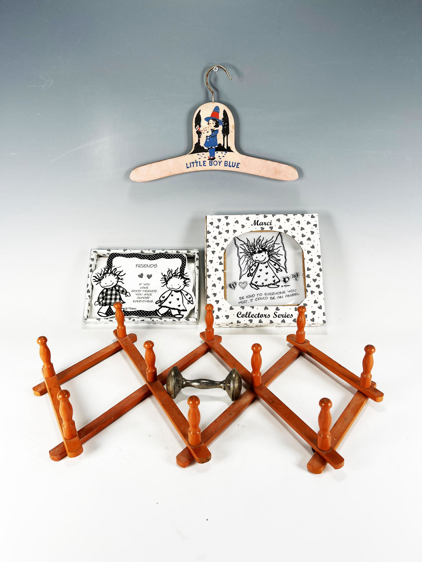 VINTAGE CHILDREN'S ROOM DECORATIONS: VINTAGE CHILDREN'S ROOM DECORATIONS Including a Little Boy Blue hanger, accordion coat rack, rattle, and two Marci plaques in box. Shipping:
