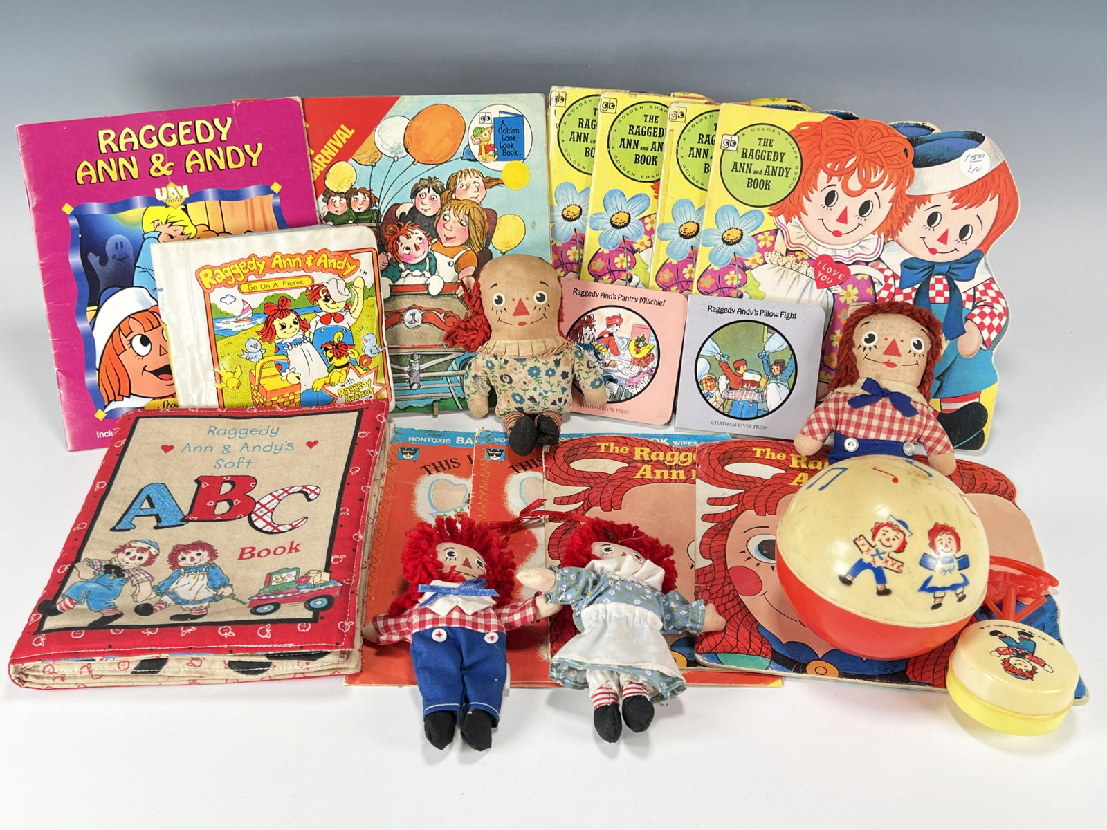 RAGGEDY ANN & ANDY BOOKS, BABY TOYS AND MINI DOLL LOT: RAGGEDY ANN & ANDY BOOKS, BABY TOYS AND MINI DOLL LOT Two 5 1/2" plus two 7" Ann and Andy dolls. Thirteen books: R. Ann's Pantry Mischief; R. Andy's Pillow Fight; R. Ann