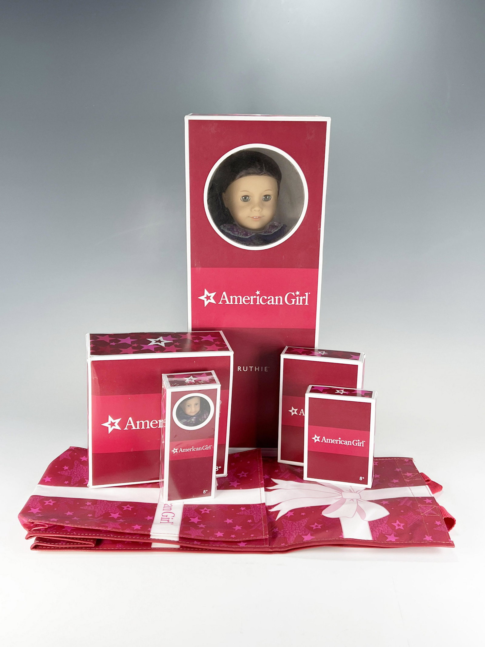 AMERICAN GIRL RUTHIE LOT IN BOX: AMERICAN GIRL RUTHIE LOT IN BOX American Girl doll Ruthie Smithens (1934) still in original box with book "Really Truly Ruthie". Extra sets included are Ruthie's play outfit,