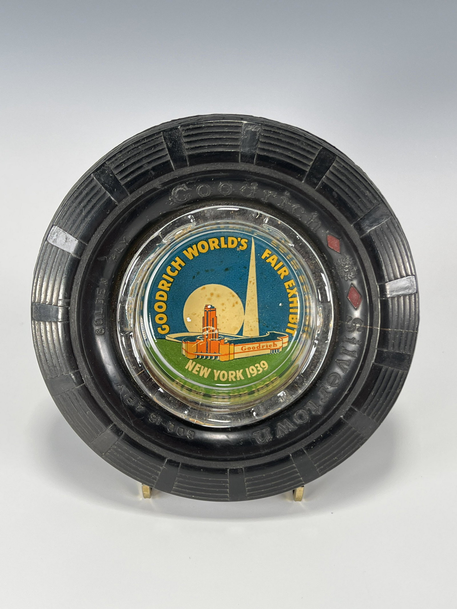 GOODRICH WORLDS FAIR NEW YORK 1939 ASHTRAY: GOODRICH WORLDS FAIR NEW YORK 1939 ASHTRAY Goodrich World's Fair Exhibit New York 1939 glass ashtray with rubber 'tire' surround. 6 1/4"