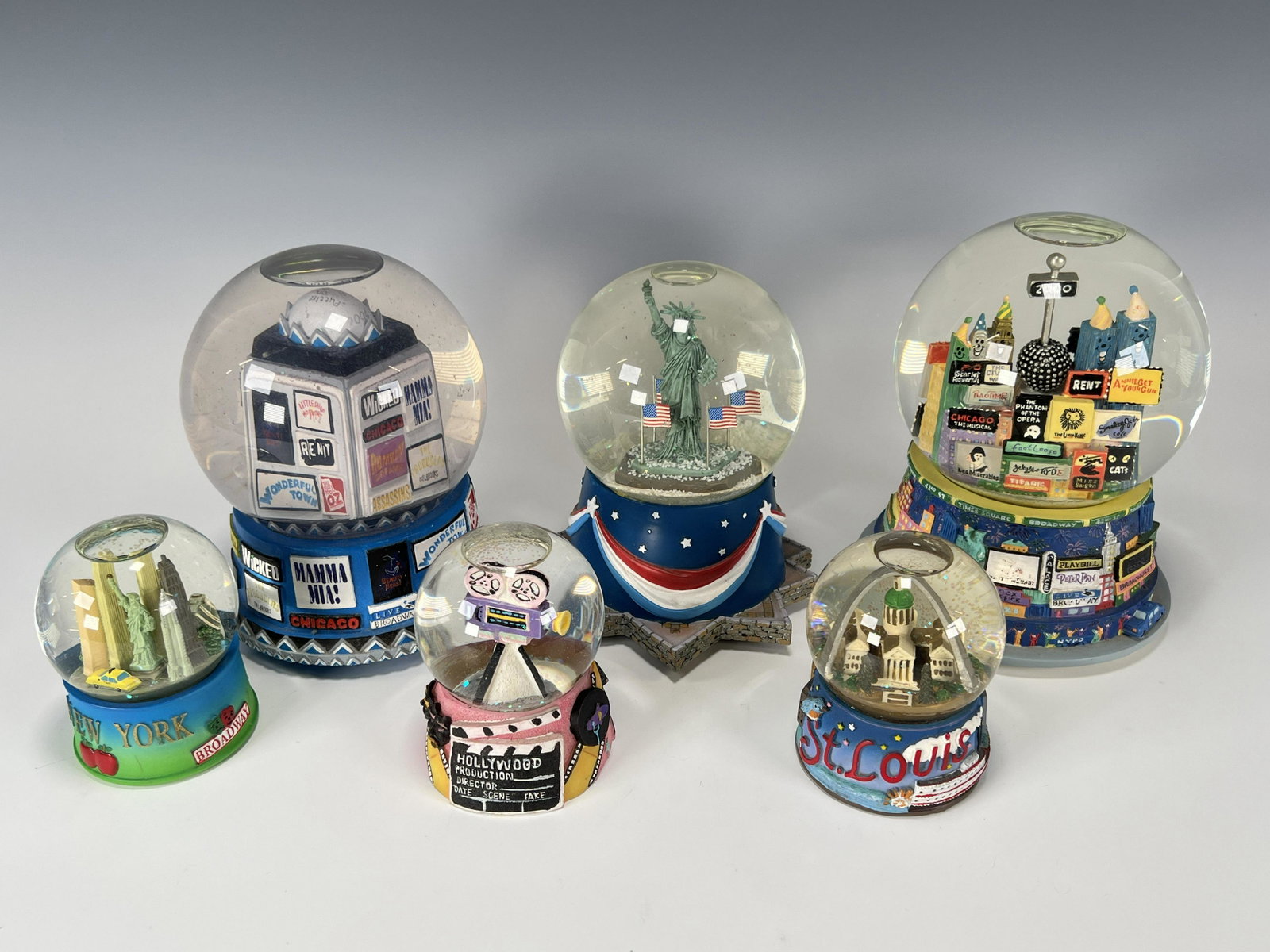 NEW YORK CITY SOUVENIR SNOW GLOBES: NEW YORK CITY SOUVENIR SNOW GLOBES Statue of Liberty, Broadway, and other iconic images of the Big Apple. Included is a St. Louis snow globe. 7"