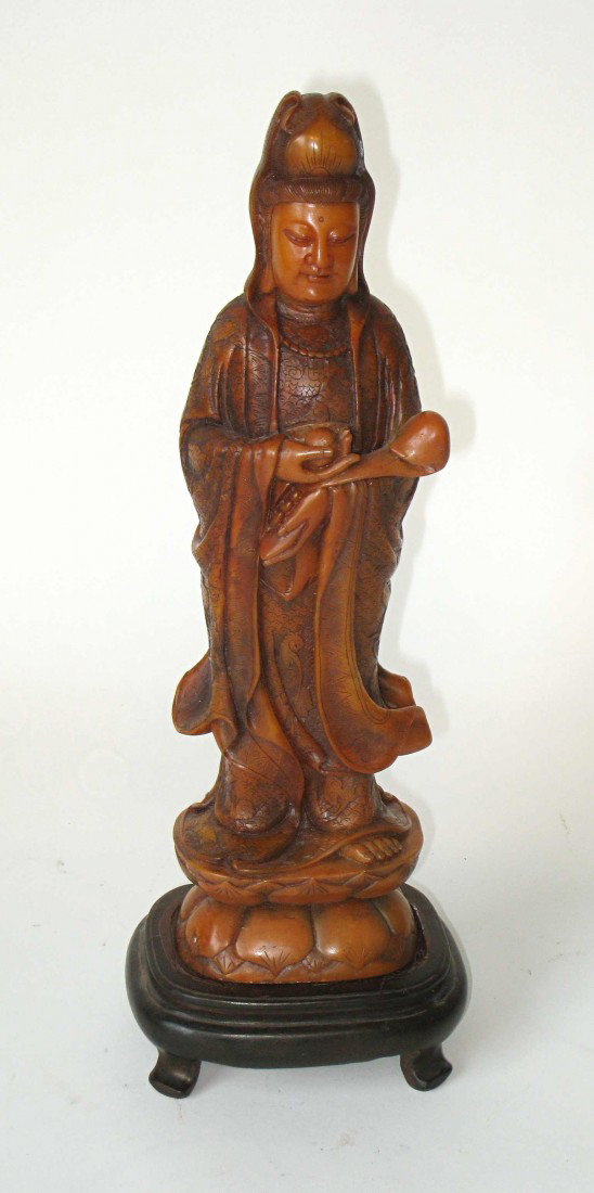 Carved Soapstone Of Quan Yin.: Quan YIn, standing as an 11 1/2" carved soapstone figure, with a wood stand.