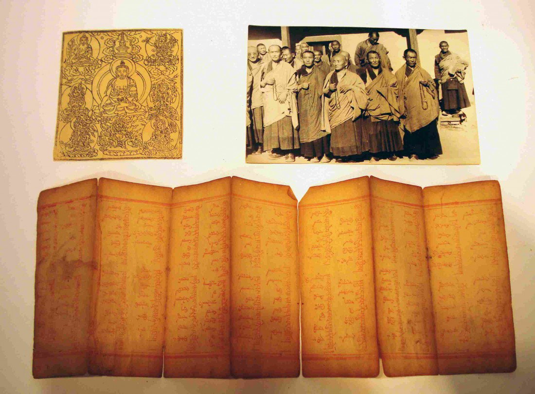 Mongolian Sutra Leaves: 18th Century Mongolian Buddhist sutra leaves, plus a black and white photograph of Tibetan monks(?) (4 1/2" X 7"); and a printed Buddha image ( 4 1/4" X 3 7/8"). The document is 5" X 14".