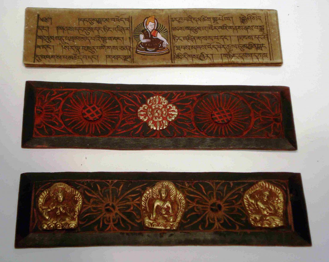 Buddhist Manuscript: A 19th century Buddhist 10 page hand lettered manuscript with each page having a central hand painted Buddha image and enclosed by two gilt and red paint decorated carved wood binders featuring inside