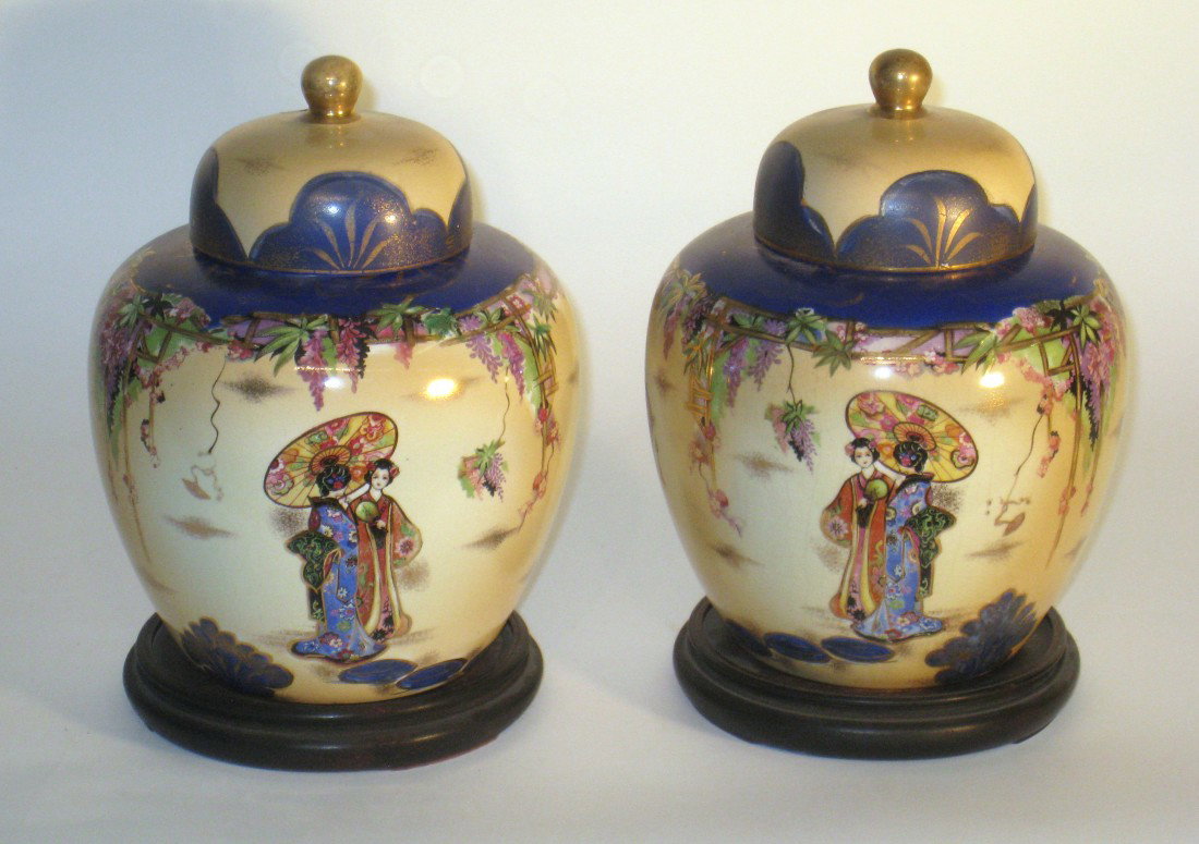 A Pair Of Kiralpo Ware Vases: Kiralpo ware, a pair of English Japanese style lidded porcelain vases, each about 9 1/2" with their wooden bases. Ca 1880-1900.