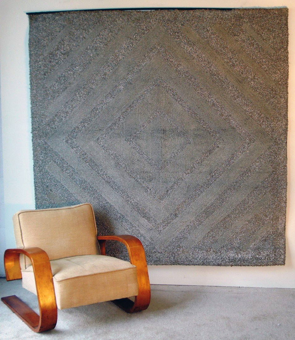 Textile Wall Hanging: An unusual textile wall hanging whose silver metallic weavings give color and texture changes to the grey and silvers.