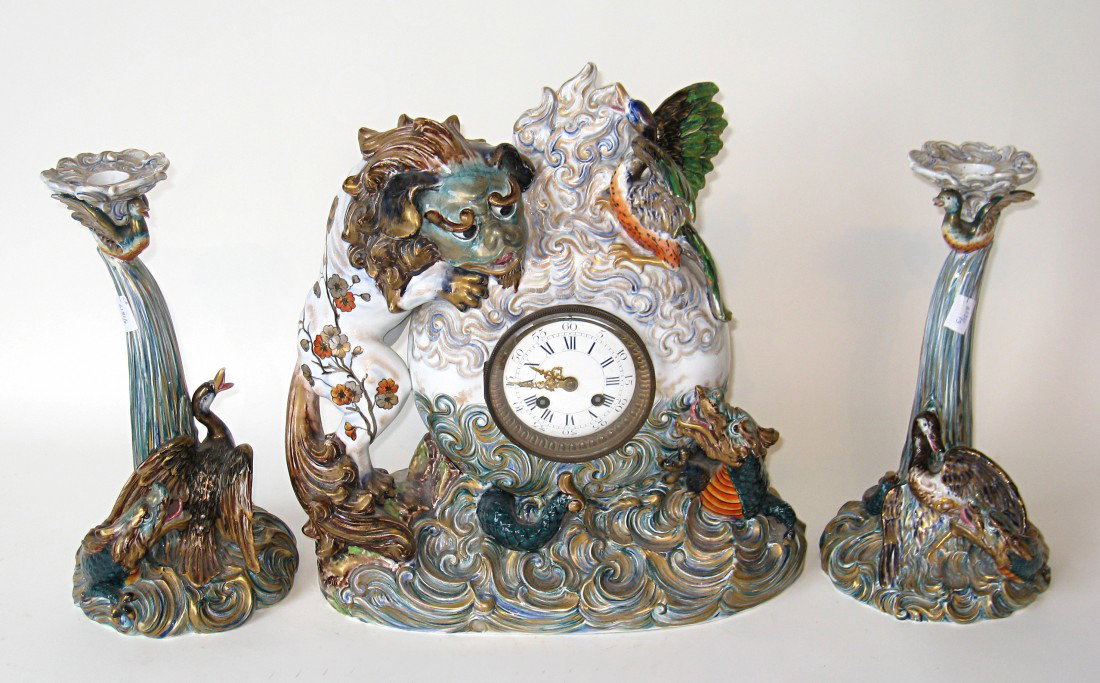 Chinese Style 3 Piece Clock Set: Fine porcelain garniture clock set in the Chinese taste. Minor damage to tip of birds wing. French made clockworks. About 1890.