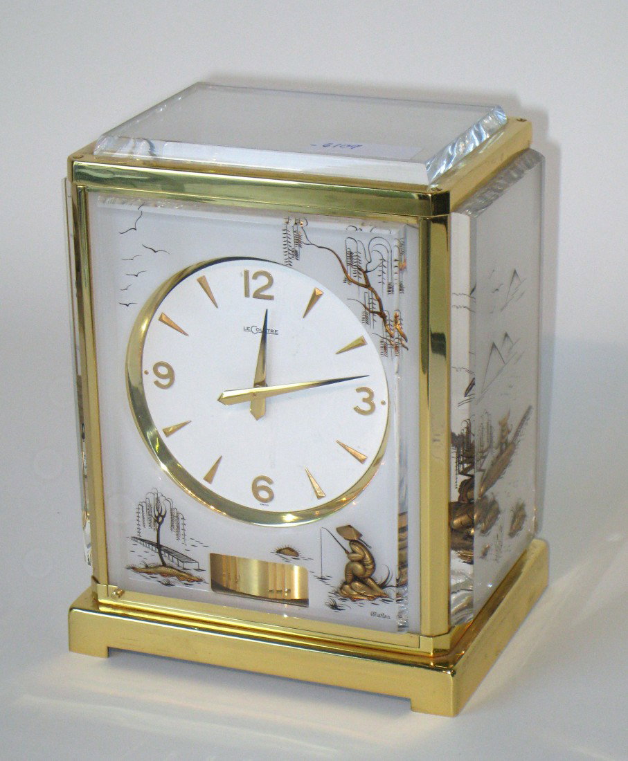 Atmos Clock: A special order Atmos clock with a gold toned framed case and etched and colored plexiglas inset panels in the Oriental taste. Serial number "244219"