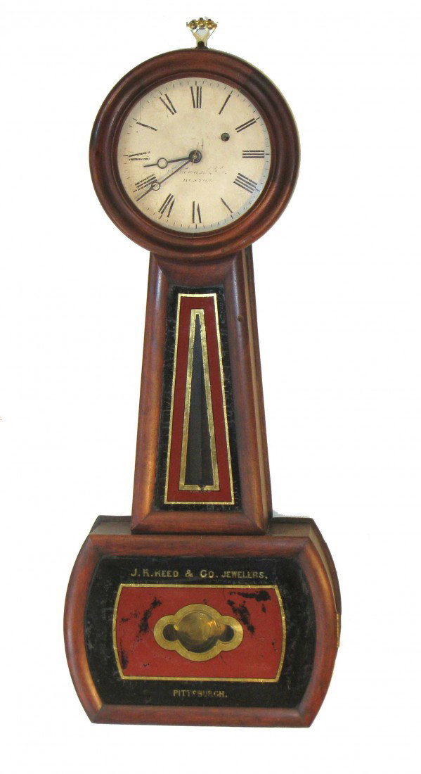 Howard Banjo Clock: A 29" cherry wood banjo timepiece with faded "E. Howard, Boston" original signature on the dial and signed in the reverse painted panel as made for "J.R. Reed & Co. Jewelers, Pittsburgh." Weight drive