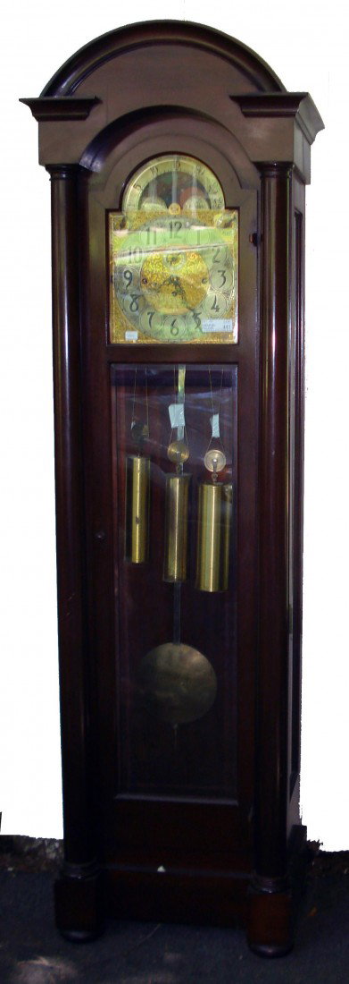 Tubular Bell Hall Clock: A mahogany cased tubular bell clock by the Herschede Clock Company featuring nine tubes with a selection of three tunes played at the quarter hours. 81" in overall height.