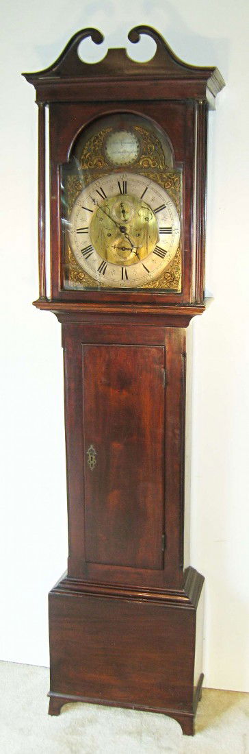 Tall Case Clock By John Kennedy: A mahogany tall case clock whose engraved brass dial has an upper signature boss signed John Kennedy, Dallington". An eight day bell strike clockworks.
