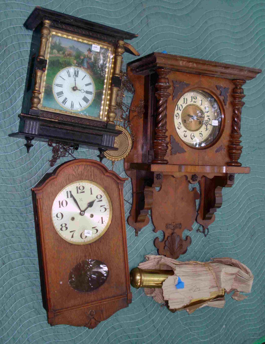 Three Clocks: Three wall clocks of German origin, one being 19th century. These are wall clocks with missing weights, etc. and in as found condition. Includes a Bavarian wall clock, chain wind, with an ebonized cas