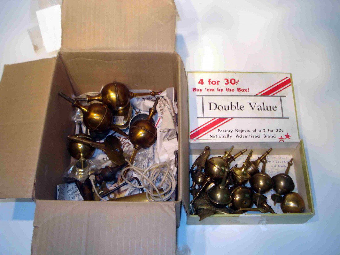 Parts And Finials: Several boxes, etc of clock parts, including some brass finials.