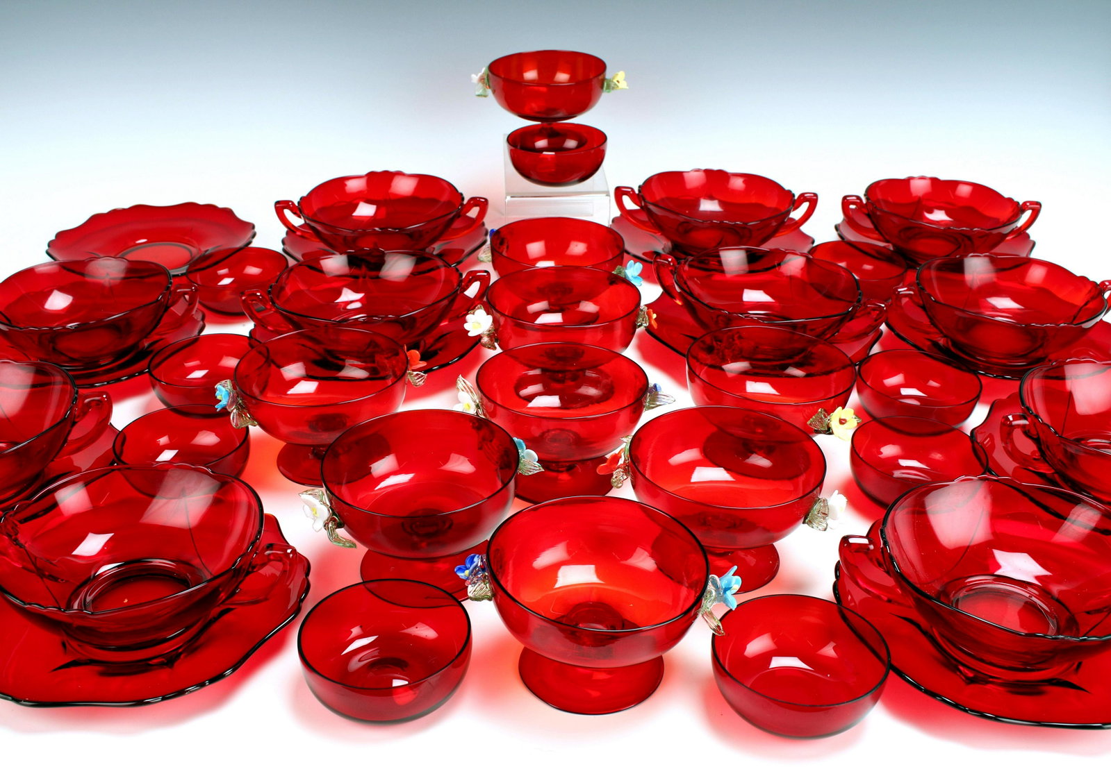 LARGE LOT CRANBERRY BLOWN GLASS & CAMBRIDGE DEPRESSION: LARGE LOT CRANBERRY BLOWN GLASS & CAMBRIDGE DEPRESSION Nine 3 3/4" blown glass pedestal bowls with applied glass flower handles, some leaves are chipped. Eleven 3" low bowl