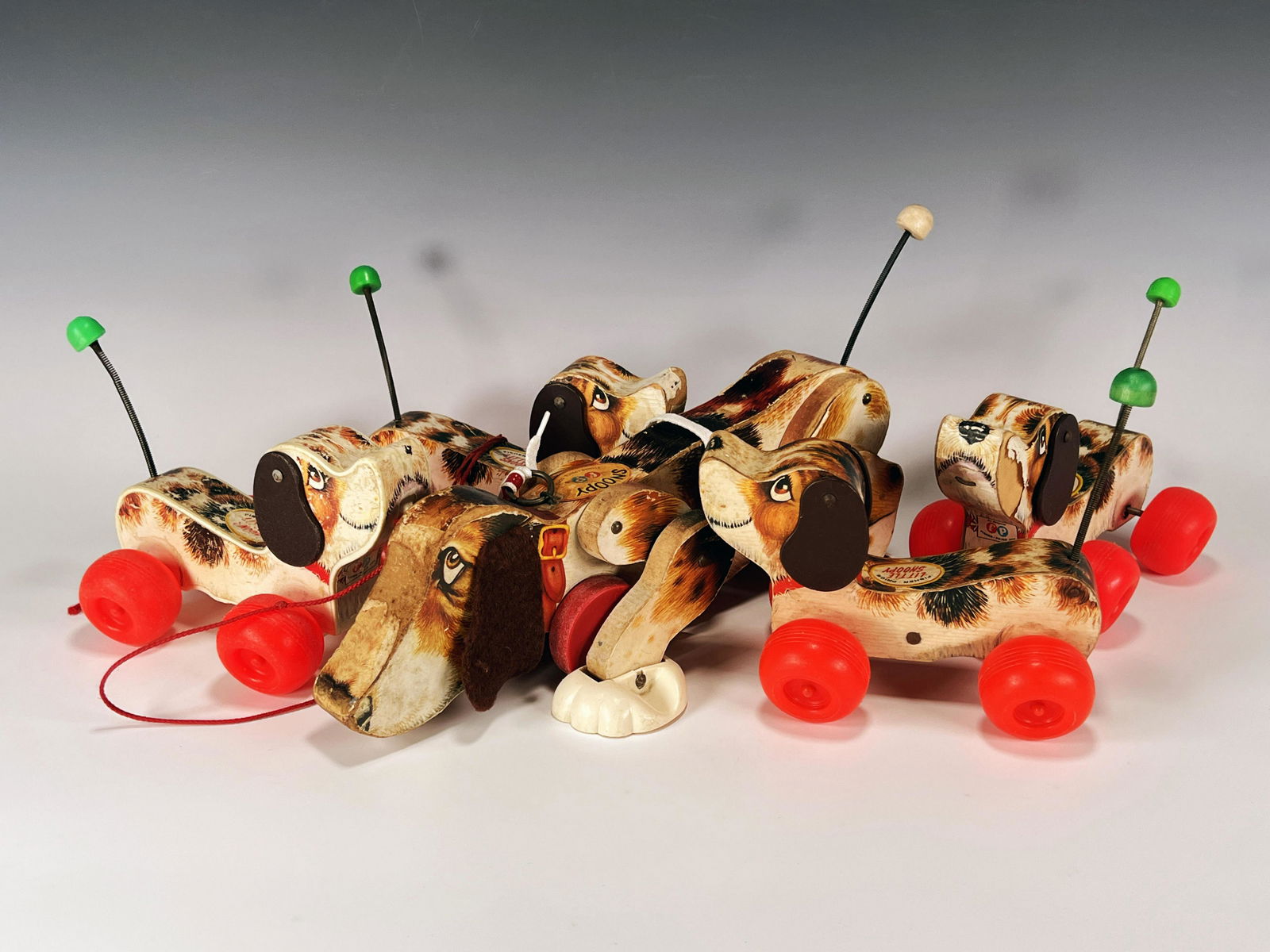 VINTAGE FISHER PRICE SNOOPY PULL TOYS: VINTAGE FISHER PRICE SNOOPY PULL TOYS Fisher Price Snoopy and four Little Snoopys. Well Loved. 13 1/2" x 6 1/4" x 7 1/2"