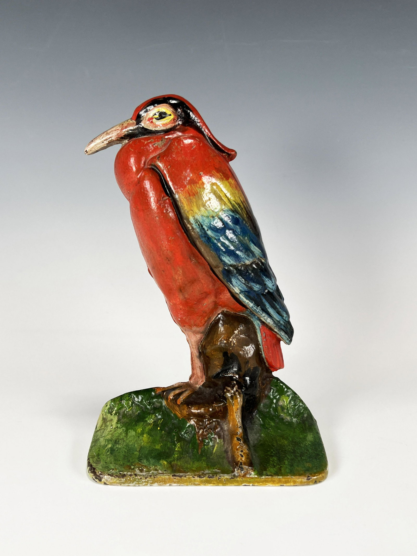 CAST IRON PAINTED FIGURAL PARROT DOOR STOP: CAST IRON PAINTED FIGURAL PARROT DOOR STOP Hand painted cast iron door stop in the form of a tropical bird. 5" X 7 1/2" Ship
