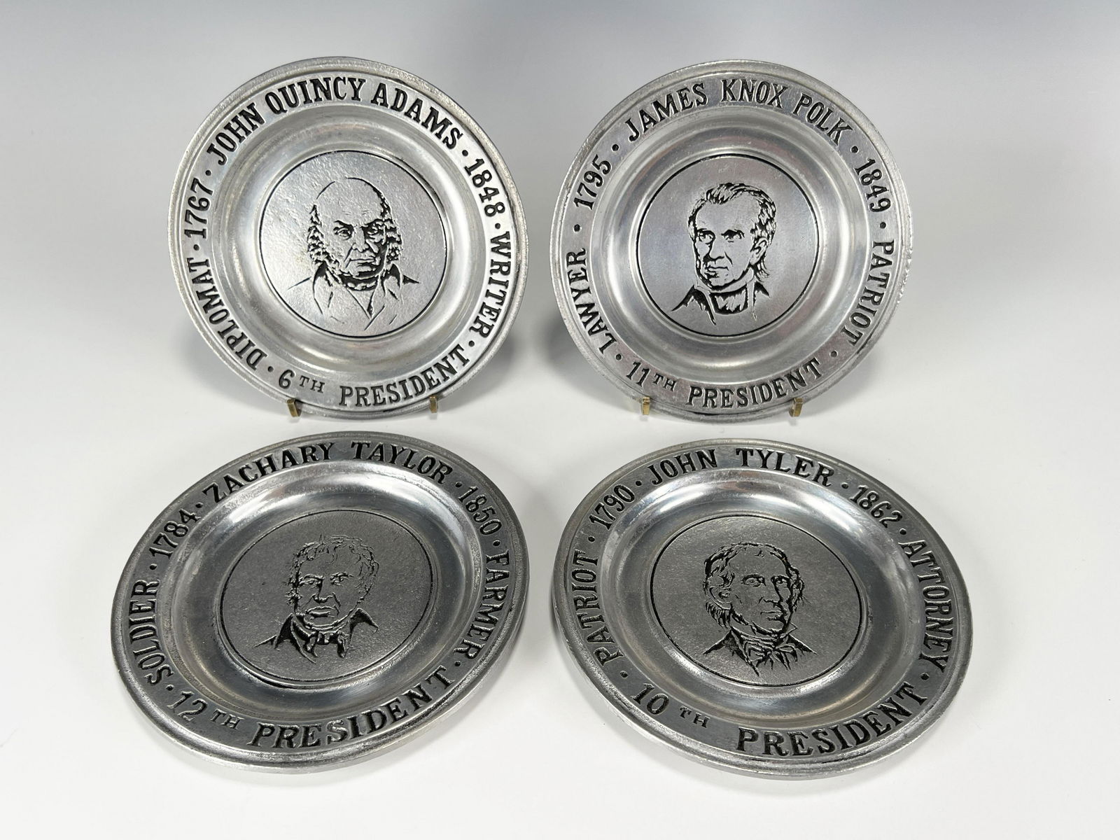 4 WILTON PEWTER PRESIDENTIAL COMMEMORATIVE DISHES: 4 WILTON PEWTER PRESIDENTIAL COMMEMORATIVE DISHES John Quincy Adams 6th president, John Taylor 10th president, James Knox Polk 11th President, Zachary Taylor 12th president. All marked W