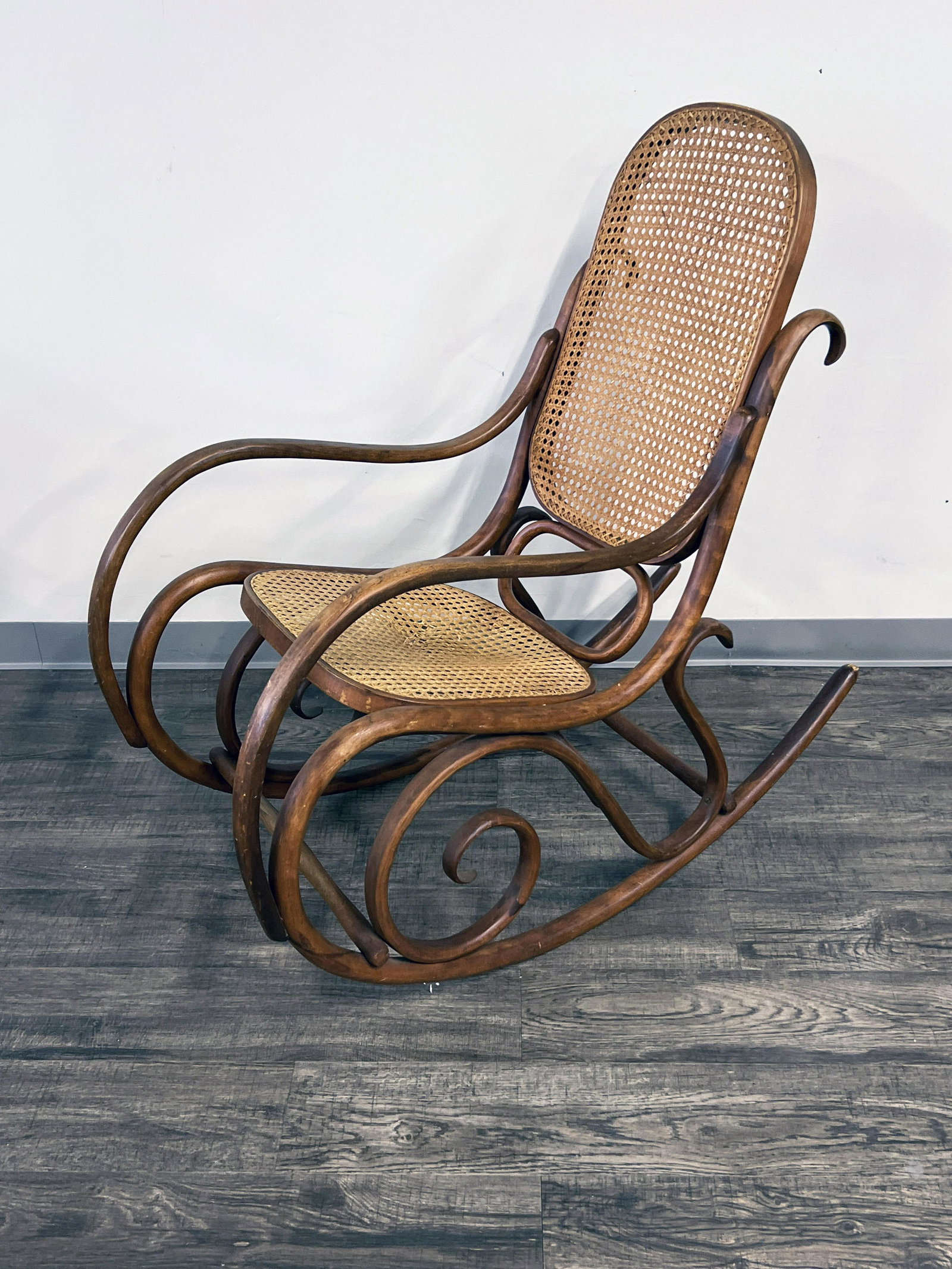 THONET STYLE BENTWOOD ROCKING CHAIR: THONET STYLE BENTWOOD ROCKING CHAIR Scrolling woodwork. Some wear to wood. 42" X 42" Shipping: