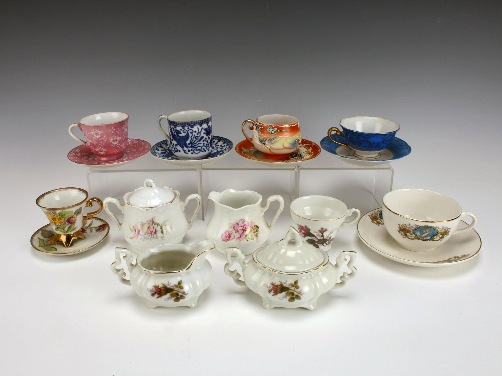 COLLECTION OF HAND PAINTED TEA CUPS & SAUCERS: COLLECTION OF HAND PAINTED TEA CUPS & SAUCERS Collection of demitasse cups and saucers, tea cups and saucers, sugars and creamers. Many marked Japan.