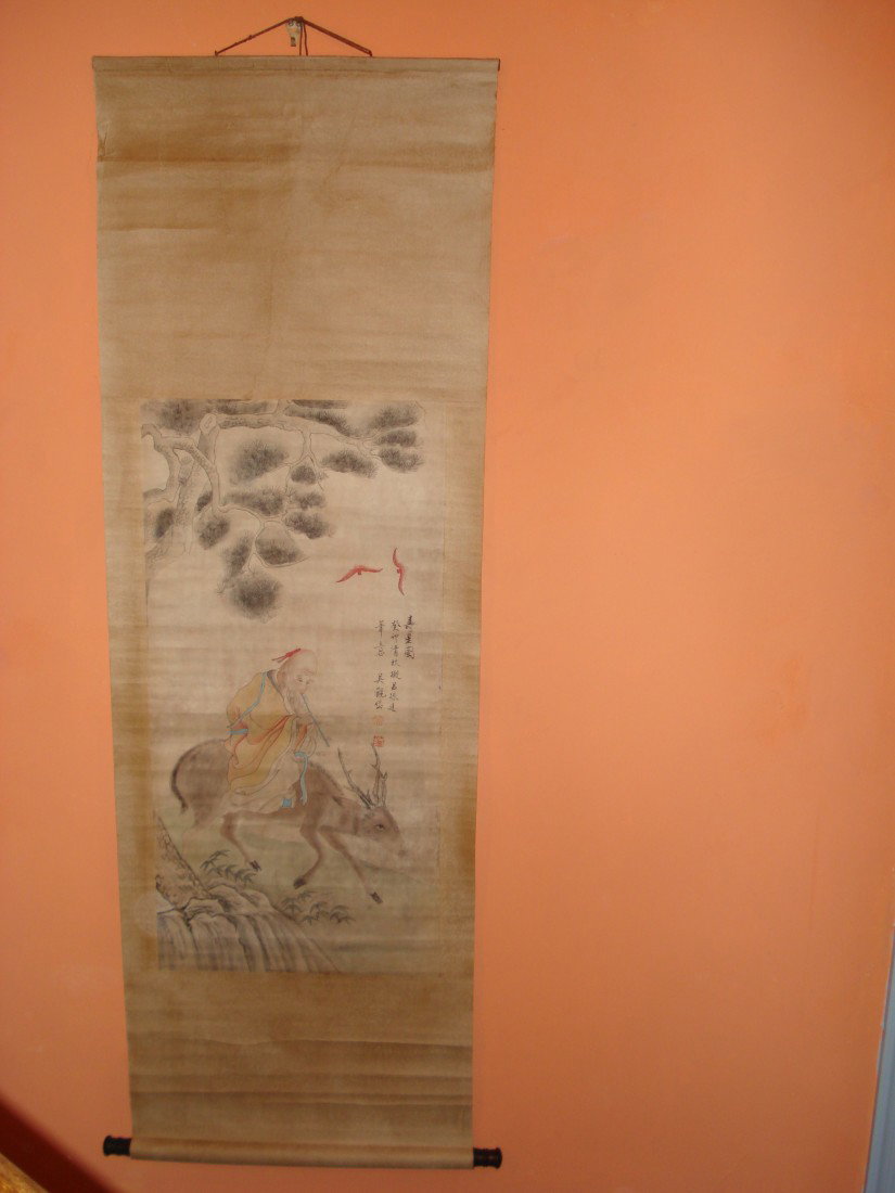 Chinese Paper Watercolor Scroll: A charming image of a man riding a horned beast within a steep mountain landscape slope, 68" X 22" with image size being 35" X 17 1/2".