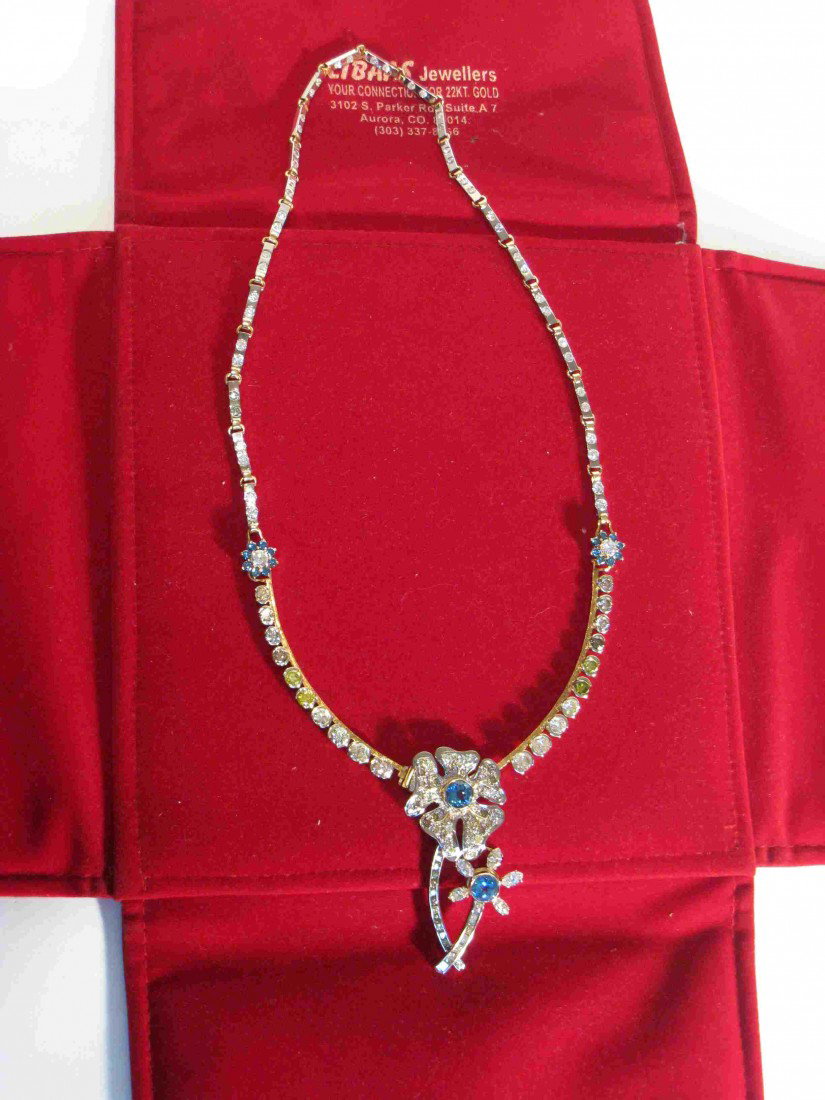 Diamond And Topaz Necklace: A diamond and topaz mounted necklace whose white and yellow gold mountings are stamped with a hallmark and "18K". This consists of colored stones totaling 4.14 ct.; and diamonds totaling 19.38 ct.; th