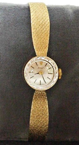 Ladies Rolex 14k Gold Tudor Wrist Watch: An unusual dress Ladies watch by Rolex with a 14K gold case and mesh wrist band. extends to 5 1/4".