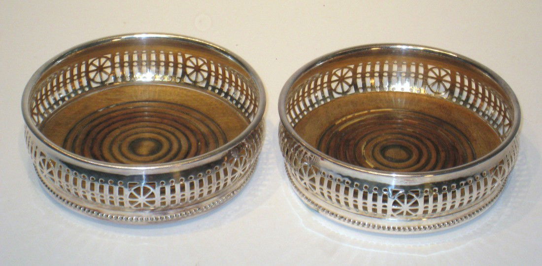 Wine Coasters: A pair of silver plate wine coasters.