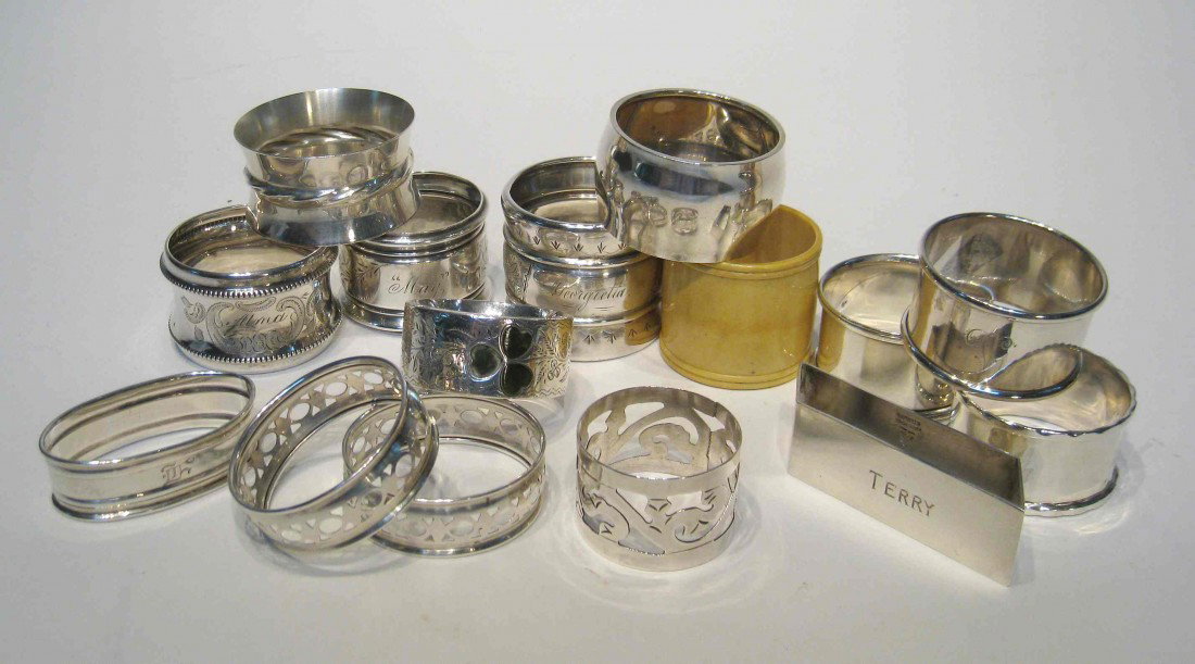 Napkin Rings: Fourteen Victorian napkin rings, with 12 being sterling and one ivory and another Mexican silver. The 12 weight 6.9 ozt.