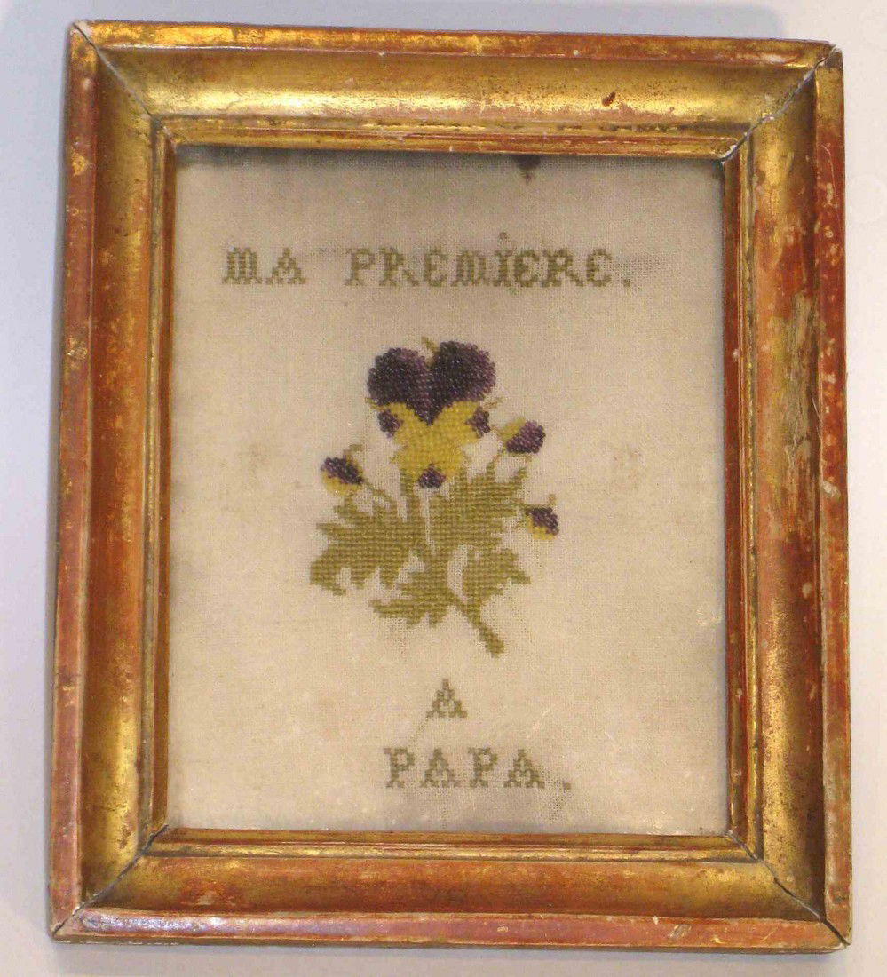 A touching sampler: A sampler, 6 1/2" X 5 1/2", with a sentiment:"Ma Premiere...a Papa", or "My very best....my father", with a label attached to the back of the original frame attesting to its early 19th century age. Th