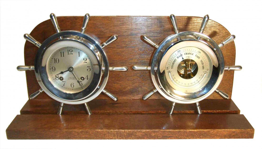 Chelsea Ships Wheel Clock Set: A chrome or nickel plated Chelsea ships bells clock. The ships bells clock has the "ships wheel" case, 8 1/2" in diameter; the weather station features an aneroid barometer and thermometer, 8 1/2". Th