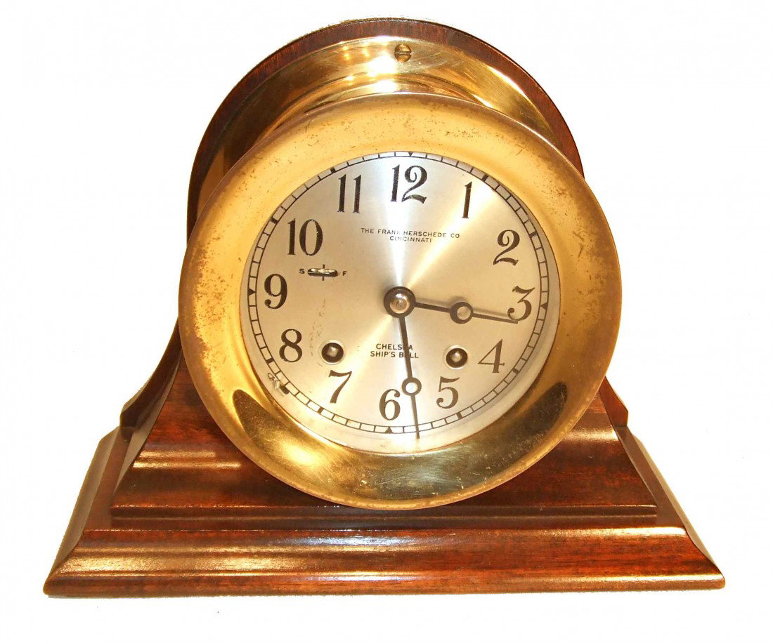 Chelsea Ships Bells Clock Signed Frank Herschede: An interesting Chelsea ships bells clock signed on the dial "The Frank Herschede Co., Cincinnati". The clock with a 7 1/4" molded wood base, with the diameter of the clock as 5 3/8" in diameter