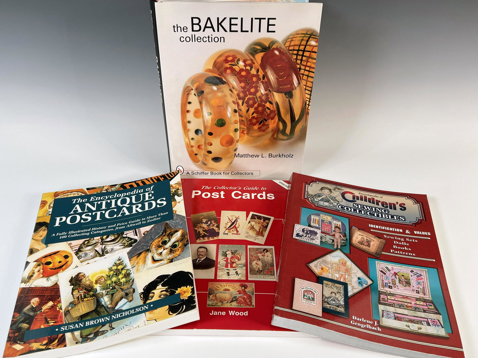 FOUR BOOKS ON COLLECTING POST CARDS, BAKELITE AND SEWING COLLECTABLES (1 of 2)