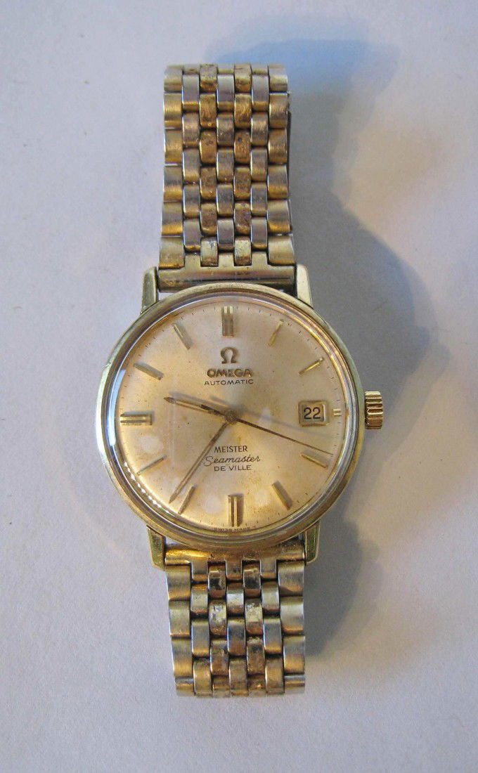 Omega "Seamaster" Wrist Watch: A gold men's self winding calendar watch by Omega, the "Seamaster DeVille".