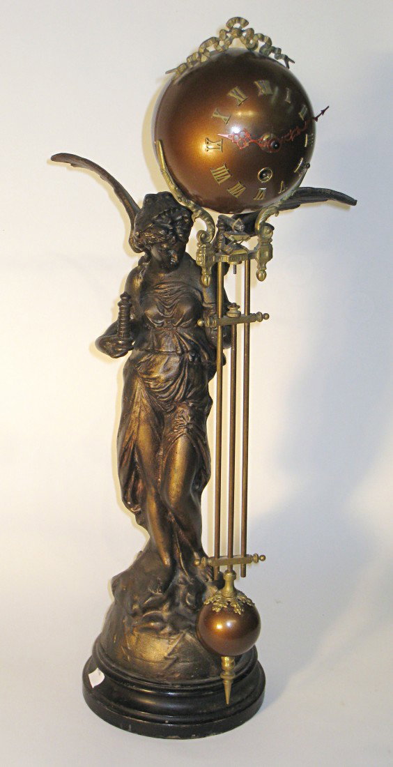 Victory Swinger: A swinger clock with a metal cast winged victory holding a 20th century swinger mystery timepiece. In poor condition, with repairs to the metal statue wings and losses of finish to the spelter casting