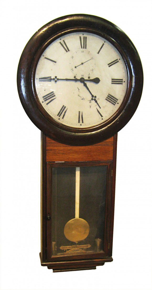 55" Tall Wall Timepiece By E. N. Welch: This with a two weight driven timepiece movement and having a rosewood veneer case. Some relatively minor flaking to the original dial paint. Dial 18 1/2" across. Lacking door key. In generally good c