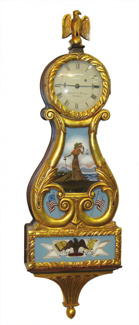 Lyre Timepiece: A 42" weight driven lyre timepiece featuring reverse painted glasses and carved and giltwood case and signed on the dial "Eurlich Romeo, Dearborn".