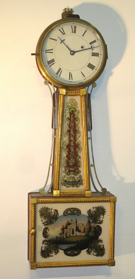 Federal Banjo Timepiece: An American New England early 19th century banjo timepiece, 29" in height and with hand reverse painted eglomise glasses depicting a building.