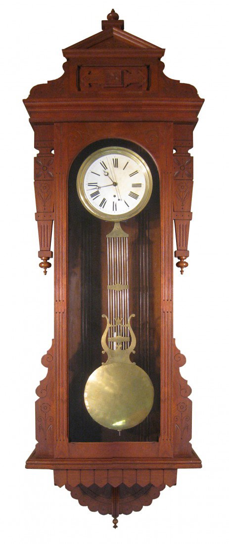 Pinwheel Regulator Wall Timepiece: A wall mounted cased pinwheel timepiece. The case with incised decoration probably by New Haven Clock Company of New Haven, Connecticut, ca 1875. The weight driven clock, of Swiss or French origin, ha