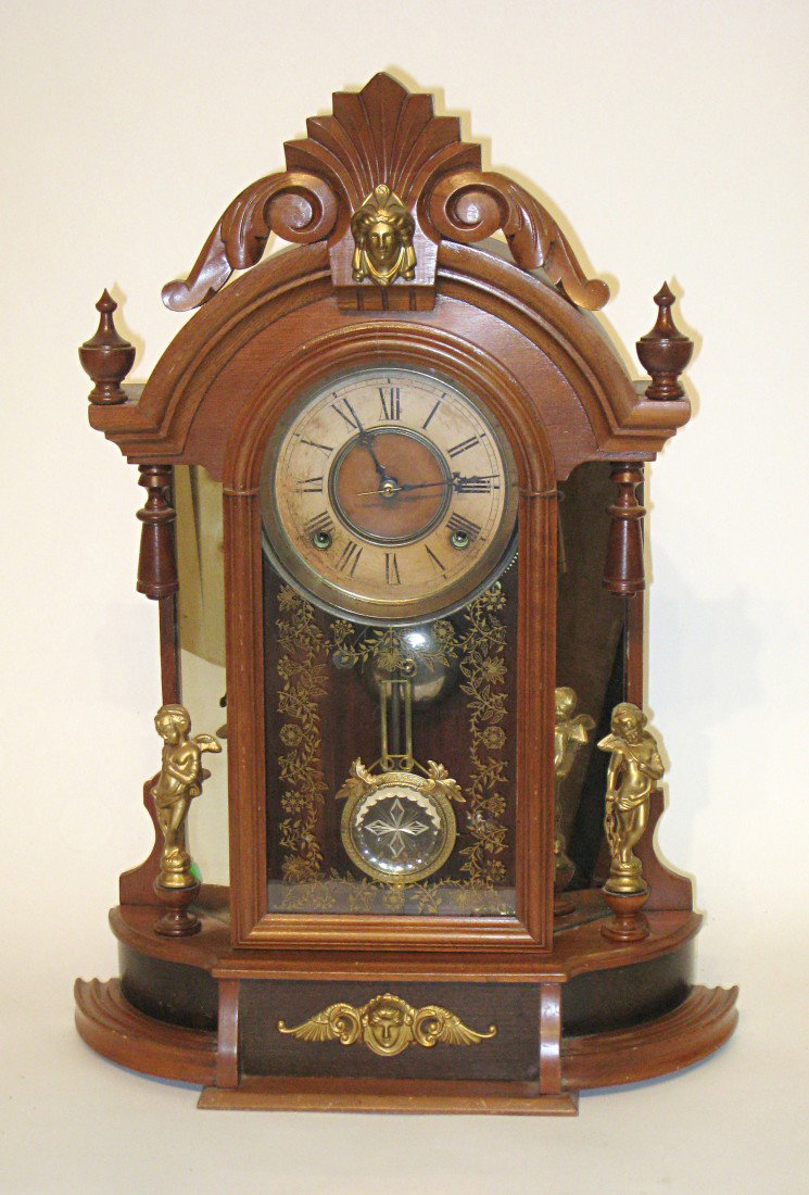Mantel Or Shelf Clock: "M. Ryan" label, with a walnut case, and with a mirrored pendulum bob.